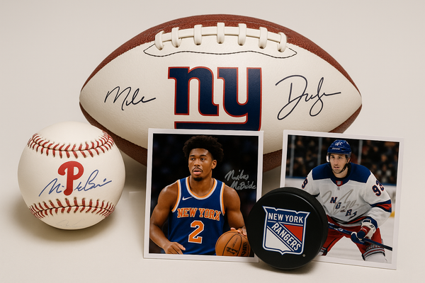 generate an image of sprots memorabelias, including:
A signed baseball by philidelphia Phillies
A signed football by ny giants
A signed photo by Miles McBride from the New York Knicks
A signed photo by and puck by the New York Rangers
the items should be close together, optimized for a small image